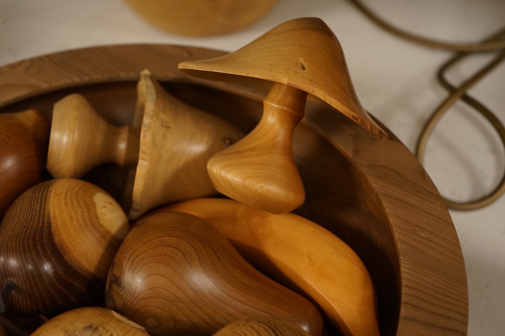 A modern treen yew bowl, a burr wood bowl and various fruit